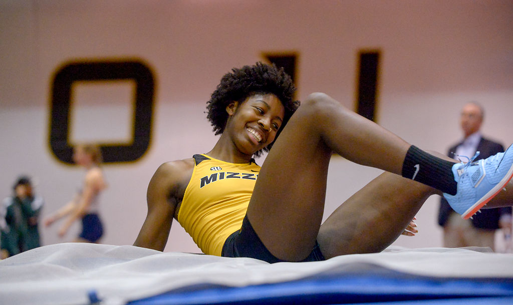 Arielle Mack smiles after landing a high jump Friday, Dec. 6, 2019 at Hearnes Field-house
